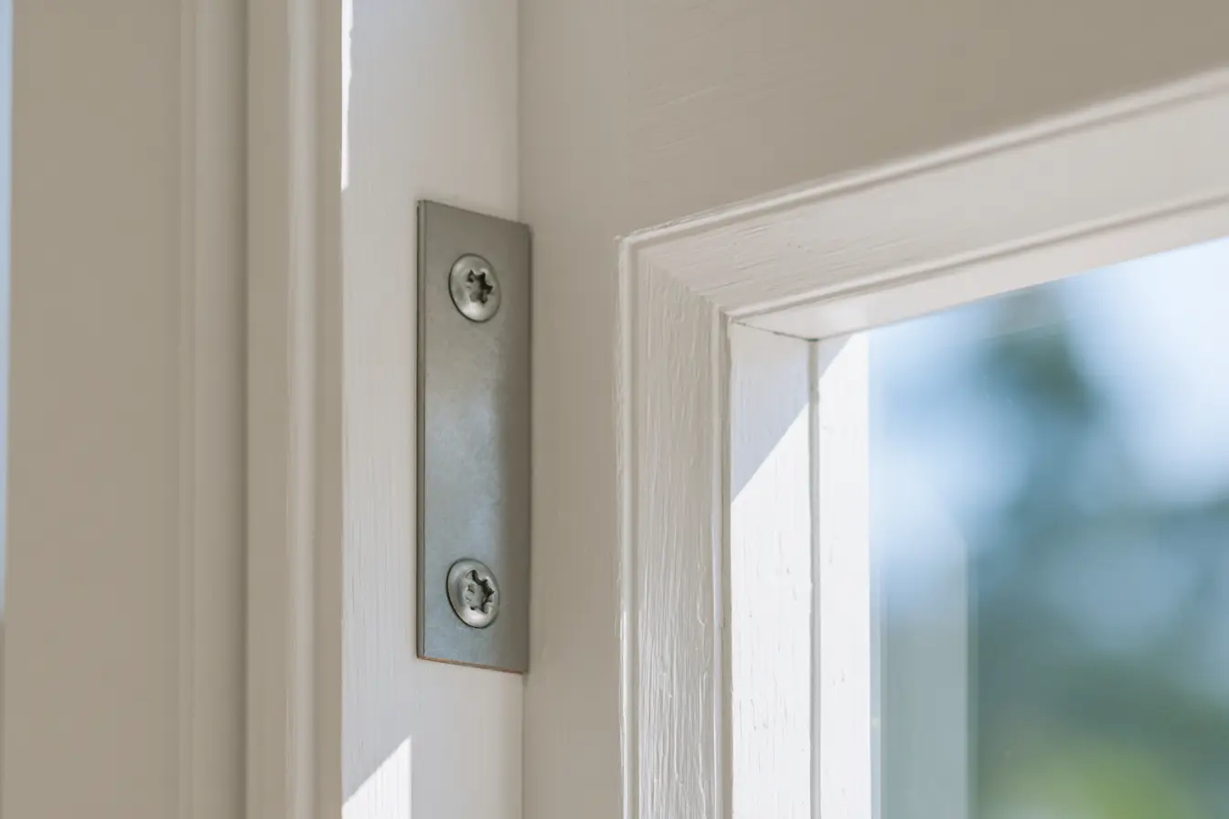 Door jamb with Door Armor steel reinforcement plate installed